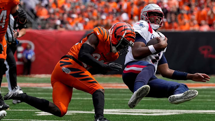 Sep 8, 2024; Cincinnati, Ohio, USA; Cincinnati Bengals cornerback Dax Hill (23) knocks from New England Patriots quarterback Jacoby Brisset as he slides on a run in the second quarter of the NFL Week 1 game between the Cincinnati Bengals and the New England Patriots at Paycor Stadium. Mandatory Credit: Sam Greene/USA TODAY Network via Imagn Images Sep 8, 2024; Cincinnati, Ohio, USA; Cincinnati Bengals cornerback Dax Hill (23) knocks from New England Patriots quarterback Jacoby Brisset as he slides on a run in the second quarter of the NFL Week 1 game between the Cincinnati Bengals and the New England Patriots at Paycor Stadium. Mandatory Credit: Sam Greene/USA TODAY Network via Imagn Images