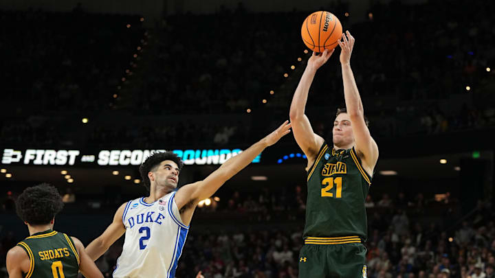 Siena forward Brendan Coyle shoots the ball over Duke guard Cayden Boozer during the men’s NCAA tournament.