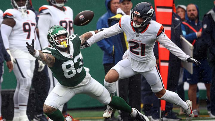 Sep 29, 2024; East Rutherford, New Jersey, USA; New York Jets tight end Tyler Conklin (83) fails to catch a pass in front of Denver Broncos cornerback Riley Moss (21) during the first half at MetLife Stadium. 