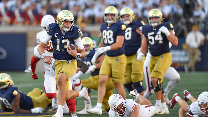 Sep 21, 2024; South Bend, Indiana, USA; Notre Dame Fighting Irish quarterback Riley Leonard (13) runs for a touchdown in the fourth quarter against the Miami Redhawks at Notre Dame Stadium. Mandatory Credit: Matt Cashore-Imagn Images