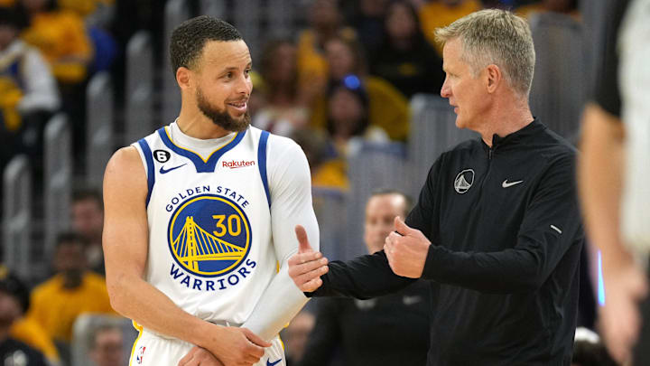 Apr 23, 2023; San Francisco, California, USA; Golden State Warriors guard Stephen Curry (30) talks with head coach Steve Kerr during the third quarter of game four of the 2023 NBA playoffs against the Sacramento Kings at Chase Center. Mandatory Credit: Darren Yamashita-Imagn Images