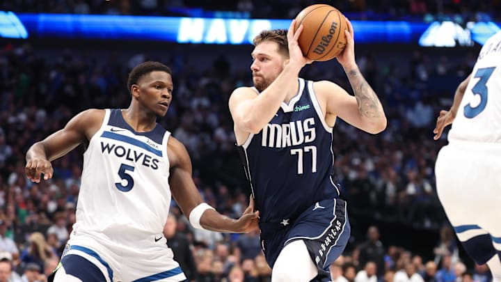Dallas Mavericks guard Luka Doncic dribbles against Minnesota Timberwolves guard Anthony Edwards.