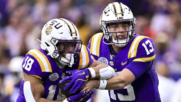 Dec 31, 2024; Houston, TX, USA; LSU Tigers quarterback Garrett Nussmeier (13) hands off the ball to running back Josh Williams (18) during the first half against the Baylor Bears at NRG Stadium. The Tigers defeat the Bears 44-31. Mandatory Credit: Maria Lysaker-Imagn Images 