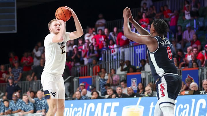 Nov 29, 2024; Paradise Island, Bahamas, BHS;  West Virginia Mountaineers guard Tucker DeVries (12) shoots over Arizona Wildcats guard Jaden Bradley (0) during the second half at Imperial Arena at the Atlantis resort.  Mandatory Credit: Kevin Jairaj-Imagn Images