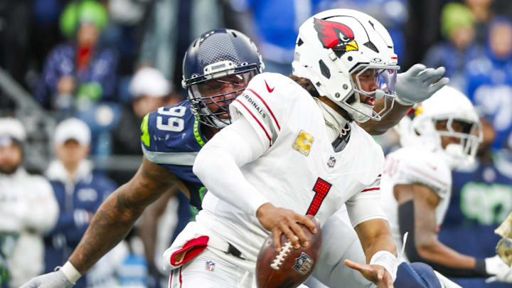 Nov 24, 2024; Seattle, Washington, USA; Arizona Cardinals quarterback Kyler Murray (1) escapes a sack attempt by Seattle Seahawks defensive end Leonard Williams (99) during the second quarter at Lumen Field. Mandatory Credit: Joe Nicholson-Imagn Images