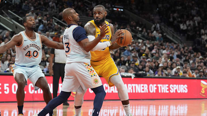 Nov 27, 2024; San Antonio, Texas, USA;  Los Angeles Lakers forward LeBron James (23) dribbles against San Antonio Spurs guard Chris Paul (3) in the second half at Frost Bank Center. Mandatory Credit: Daniel Dunn-Imagn Images