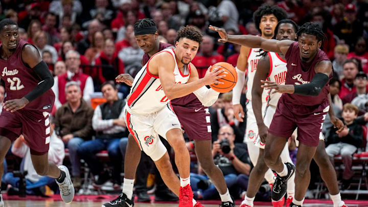 Dec 29, 2022; Columbus, Ohio, United States;  Ohio State Buckeyes guard Tanner Holden (0) is thrown off balance after running into Alabama Bulldogs center Olisa Blaise Akonobi (33) during the second half of the NCAA division I basketball game between the Ohio State Buckeyes and the Alabama A&M Bulldogs at Value City Arena. Mandatory Credit: Joseph Scheller-The Columbus DispatchBasketball Ceb Mbk Alabama Alabama A M At Ohio State