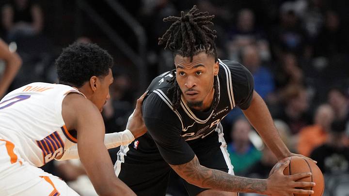 Oct 10, 2026; Phoenix, Arizona, USA; San Antonio Spurs guard Stephon Castle (5) shields the ball from Phoenix Suns forward Ryan Dunn (0) in the second half at Mortgage Matchup Center. Oct 10, 2026; Phoenix, Arizona, USA; San Antonio Spurs guard Stephon Castle (5) shields the ball from Phoenix Suns forward Ryan Dunn (0) in the second half at Mortgage Matchup Center.