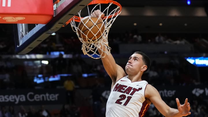 Miami Heat forward Cole Swider (21) dunks the ball.