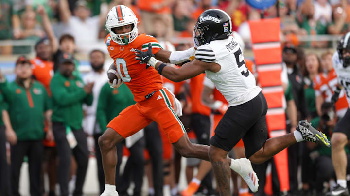 Dec 28, 2024; Orlando, FL, USA; Miami Hurricanes wide receiver Joshisa Trader (0) holds off Iowa State Cyclones defensive back Myles Purchase (5) in the second quarter during the Pop Tarts bowl at Camping World Stadium. Mandatory Credit: Nathan Ray Seebeck-Imagn Images Dec 28, 2024; Orlando, FL, USA; Miami Hurricanes wide receiver Joshisa Trader (0) holds off Iowa State Cyclones defensive back Myles Purchase (5) in the second quarter during the Pop Tarts bowl at Camping World Stadium. Mandatory Credit: Nathan Ray Seebeck-Imagn Images