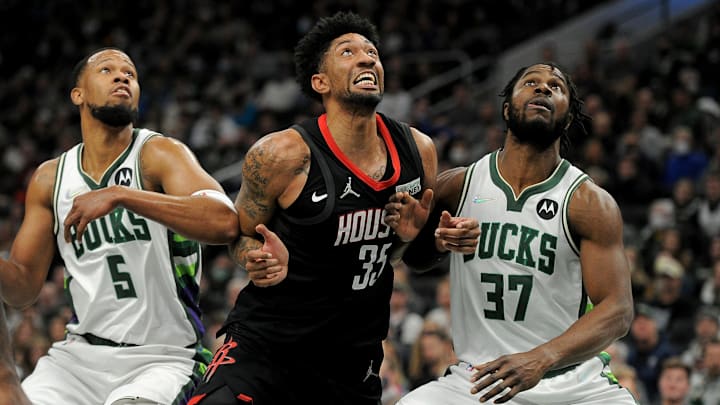 Dec 22, 2021; Milwaukee, Wisconsin, USA;  Milwaukee Bucks guard Rodney Hood (5), Houston Rockets center Christian Wood (35) and Milwaukee Bucks forward Semi Ojeleye (37) battle for a rebound after a missed free throw in the second half at Fiserv Forum. Mandatory Credit: Michael McLoone-Imagn Images