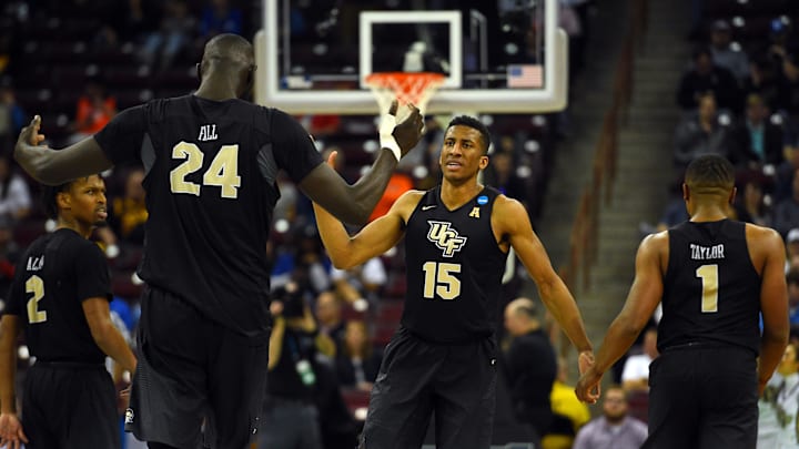 Mar 22, 2019; Columbia, SC, USA; UCF Knights guard Aubrey Dawkins (15) and center Tacko Fall (24) and guard B.J. Taylor (1) celebrate during the second half against the Virginia Commonwealth Rams in the first round of the 2019 NCAA Tournament at Colonial Life Arena. Mandatory Credit: Bob Donnan-Imagn Images