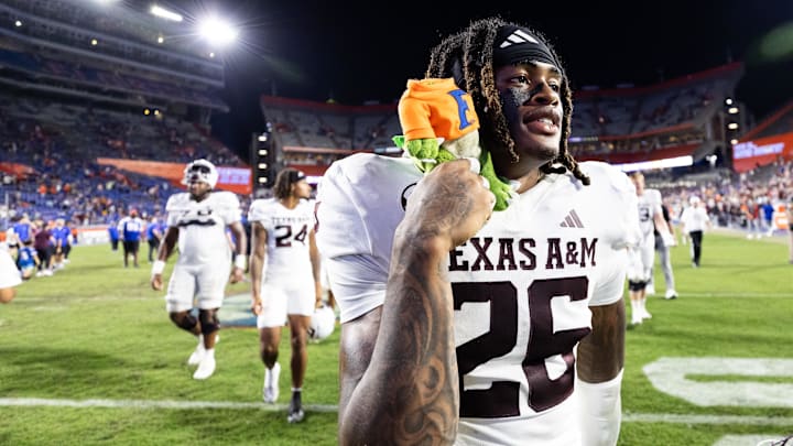 Sep 14, 2024; Gainesville, Florida, USA; Texas A&M Aggies defensive back Will Lee III (26) holds a Florida Gator plush toy after defeating the Florida Gators at Ben Hill Griffin Stadium. Mandatory Credit: Matt Pendleton-Imagn Images