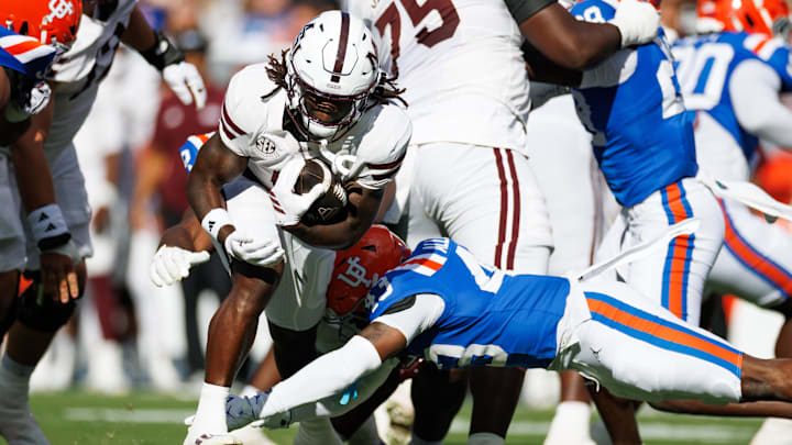 Florida Gators defensive back Alfonzo Allen Jr. (43) tackles Mississippi State Bulldogs running back Davon Booth (6) during the first half at Ben Hill Griffin Stadium.