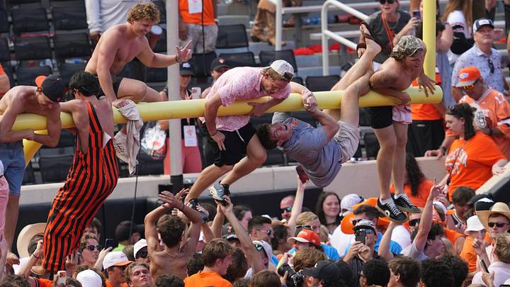 Oklahoma State fans tear down a goalpost after a win over Oregon. Oklahoma State fans tear down a goalpost after a win over Oregon.