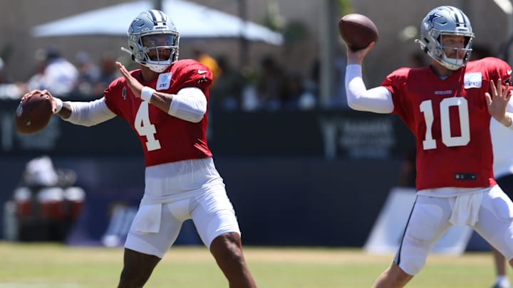Dallas Cowboys quarterback Dak Prescott throws next to quarterback Cooper Rush during training camp.