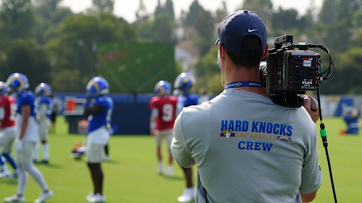 An HBO Hard Knocks cameraman shoots video footage at Los Angeles Rams training camp practice.
