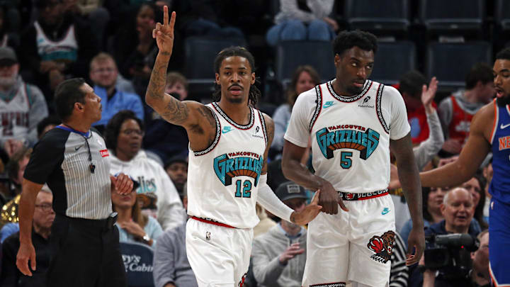 Feb 28, 2025; Memphis, Tennessee, USA; Memphis Grizzlies guard Ja Morant (12) reacts with guard Vince Williams Jr. (5) during the first quarter against the New York Knicks at FedExForum. Mandatory Credit: Petre Thomas-Imagn Images
