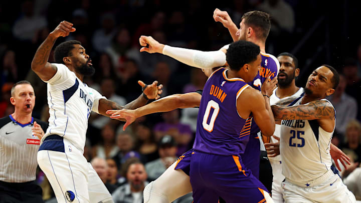 Dec 27, 2024; Phoenix, Arizona, USA; Dallas Mavericks forward Naji Marshall (13) punches Phoenix Suns center Jusuf Nurkic (20) during the third quarter at Footprint Center. Mandatory Credit: Mark J. Rebilas-Imagn Images