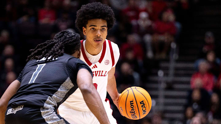 Louisville Cardinals guard Mikel Brown (0) handles the ball as Cincinnati Bearcats guard Day Day Thomas (1) guards him in the first half of the NCAA Basketball game at Heritage Bank Center in Cincinnati on Nov. 21, 2025. Louisville Cardinals guard Mikel Brown (0) handles the ball as Cincinnati Bearcats guard Day Day Thomas (1) guards him in the first half of the NCAA Basketball game at Heritage Bank Center in Cincinnati on Nov. 21, 2025.