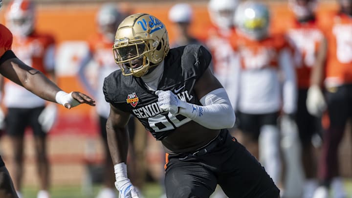 Jan 29, 2025; Mobile, AL, USA; National team defensive lineman Oluwafemi Oladejo of UCLA (99) runs through a drill during Senior Bowl practice at Hancock Whitney Stadium. Mandatory Credit: Vasha Hunt-Imagn Images