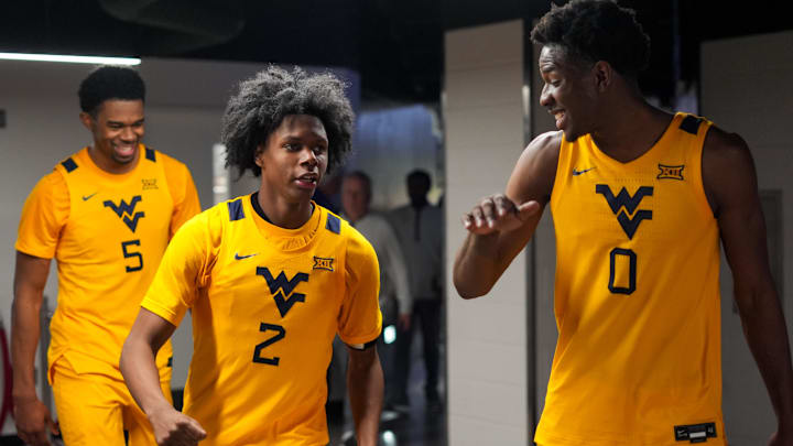 Feb 5, 2026; Cincinnati, Ohio, USA; West Virginia Mountaineers guard Amir Jenkins (2) and forward Brenen Lorient (0) celebrate after their team’s win against the Cincinnati Bearcats at Fifth Third Arena. Mandatory Credit: Aaron Doster-Imagn Images