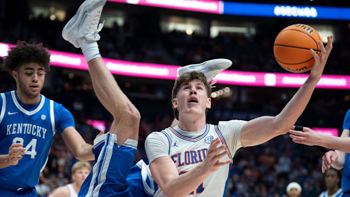 Kentucky guard Collin Chandler (5) goes over Florida forward Alex Condon (21) under the basket during their quarterfinal game of the 2026 SEC Men’s Basketball Tournament at Bridgestone Arena in Nashville, Tenn., Friday, March 13, 2026. Kentucky guard Collin Chandler (5) goes over Florida forward Alex Condon (21) under the basket during their quarterfinal game of the 2026 SEC Men’s Basketball Tournament at Bridgestone Arena in Nashville, Tenn., Friday, March 13, 2026.