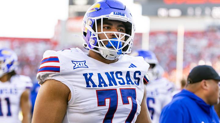 Nov 8, 2025; Tucson, Arizona, USA; Kansas Jayhawks offensive lineman Enrique Cruz Jr. (77) against the Arizona Wildcats at Arizona Stadium. Mandatory Credit: Mark J. Rebilas-Imagn Images