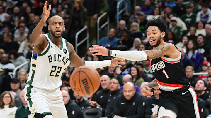 Jan 4, 2025; Milwaukee, Wisconsin, USA; Portland Trail Blazers guard Anfernee Simons (1) passes the ball away from Milwaukee Bucks forward Khris Middleton (22) in the second quarter at Fiserv Forum. Mandatory Credit: Benny Sieu-Imagn Images