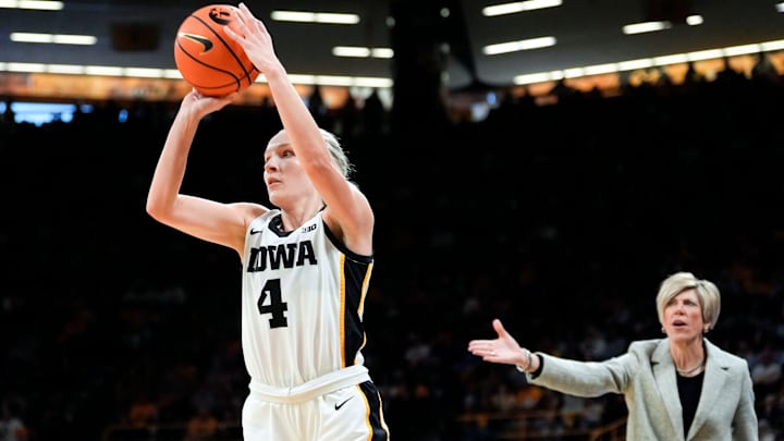 Iowa Hawkeyes guard Kylie Feuerbach (4) attempts a three-point basket against the Purdue Boilermakers Sunday, Dec. 29, 2024 at Carver-Hawkeye Arena in Iowa City, Iowa.