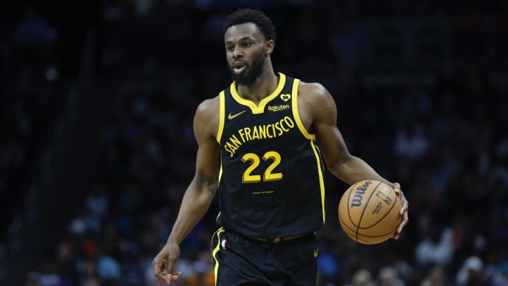 Warriors forward Andrew Wiggins brings the ball up court against the Charlotte Hornets during a game in March 2024.