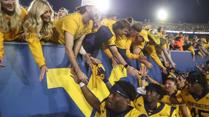 Sep 7, 2024; Morgantown, West Virginia, USA; West Virginia Mountaineers players celebrate with fans after defeating the Albany Great Danes at Mountaineer Field at Milan Puskar Stadium. Sep 7, 2024; Morgantown, West Virginia, USA; West Virginia Mountaineers players celebrate with fans after defeating the Albany Great Danes at Mountaineer Field at Milan Puskar Stadium.