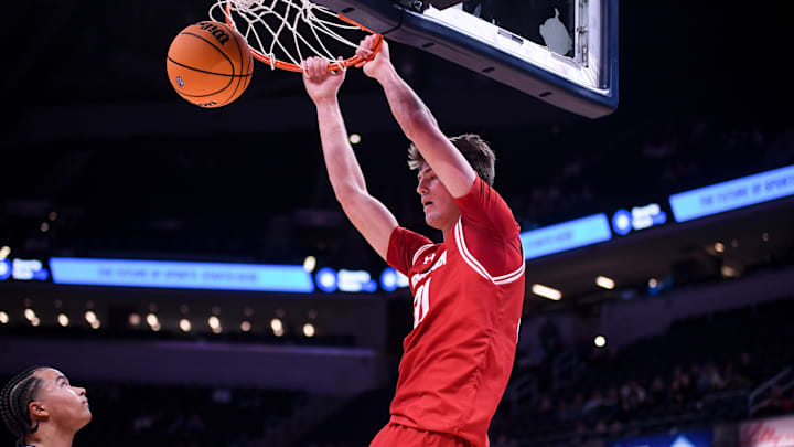 Dec 14, 2024; Indianapolis, Indiana, USA;  Wisconsin Badgers forward Nolan Winter (31) dunks the ball in front of Butler Bulldogs guard Landon Moore (14) during the second half at Gainbridge Fieldhouse. Mandatory Credit: Robert Goddin-Imagn Images