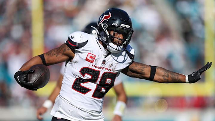 Dec 1, 2024; Jacksonville, Florida, USA; Houston Texans running back Joe Mixon (28) runs with the ball against the Jacksonville Jaguars in the second quarter at EverBank Stadium. Mandatory Credit: Nathan Ray Seebeck-Imagn Images