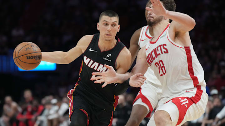Mar 21, 2025; Miami, Florida, USA;  Miami Heat guard Tyler Herro (14) drives to the basket as Houston Rockets center Alperen Sengun (28) defends in the second half at Kaseya Center. Mandatory Credit: Jim Rassol-Imagn Images