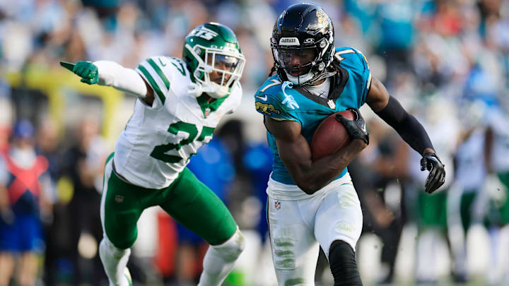 Jacksonville Jaguars wide receiver Brian Thomas Jr. (7) rushes for yards en route to a touchdown against New York Jets cornerback Kendall Sheffield (27) during the fourth quarter Sunday, Dec. 15.