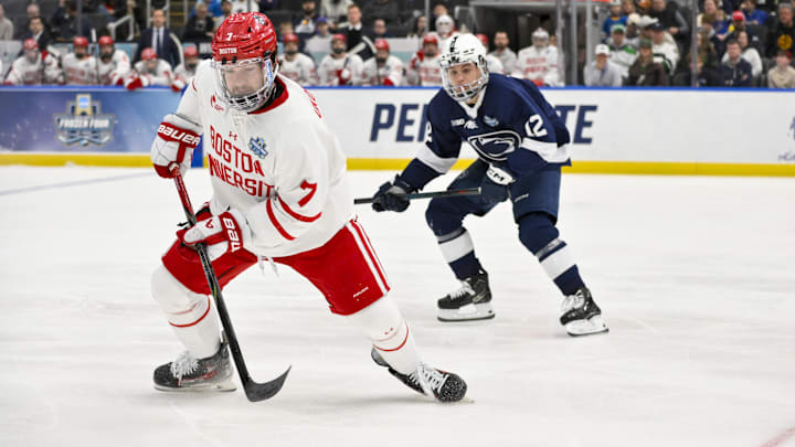 Apr 10, 2025; St. Louis, Missouri, UNITED STATES; Boston University Terriers forward Nick Roukounakis (7) controls the puck against the Penn State Nittany Lions during the first period of the Frozen Four college ice hockey national semifinals at Enterprise Center. Mandatory Credit: Jeff Curry-Imagn Images