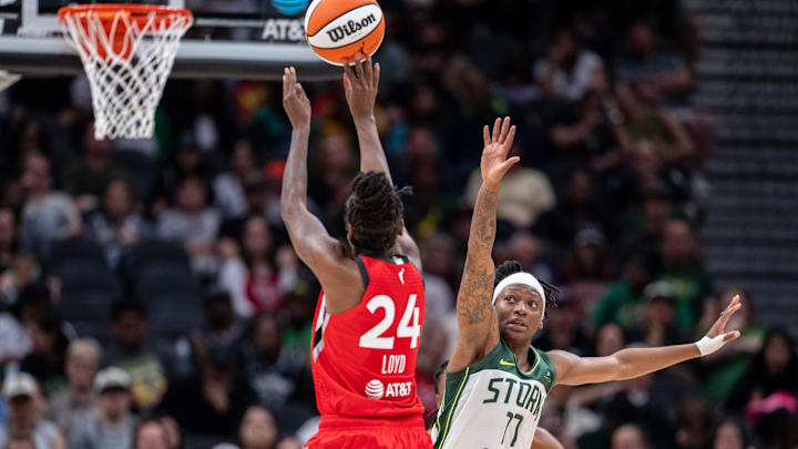 May 25, 2025; Seattle, Washington, USA;  Seattle Storm guard Erica Wheeler (17) defends a shot by Las Vegas Aces guard Jewell Loyd (24) during the second half at Climate Pledge Arena. Mandatory Credit: Stephen Brashear-Imagn Images
