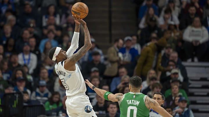 Minnesota Timberwolves forward Jaden McDaniels shoots over Boston Celtics forward Jayson Tatum in the first half at Target Center in Minneapolis on Jan. 2, 2025. 