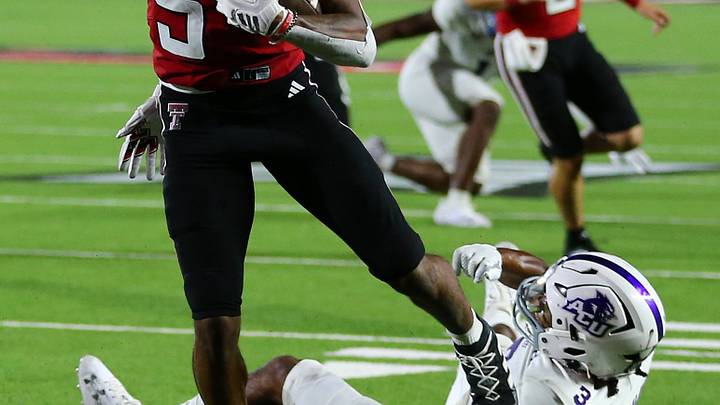 Texas Tech Red Raiders wide receiver scores a touchdown against Abilene Christian Wildcats' defensive safety. Mandatory Credit: Michael C. Johnson-USA TODAY Sports Texas Tech Red Raiders wide receiver scores a touchdown against Abilene Christian Wildcats' defensive safety. Mandatory Credit: Michael C. Johnson-USA TODAY Sports