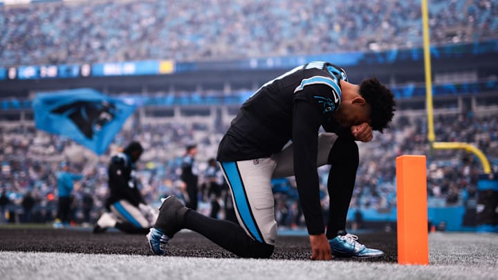 Nov 30, 2025; Charlotte, North Carolina, USA; Carolina Panthers quarterback Bryce Young (9) kneels before the game against the Los Angeles Rams at Bank of America Stadium. Mandatory Credit: Scott Kinser-Imagn Images