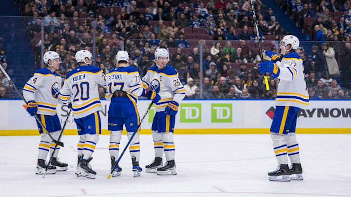 Jan 21, 2025; Vancouver, British Columbia, CAN; Buffalo Sabres defenseman Bowen Byram (4) and forward Jiri Kulich (20) and forward JJ Peterka (77) and defenseman Rasmus Dahlin (26) and forward Tage Thompson (72) celebrate Peterka’s goal against the Vancouver Canucks in the third period at Rogers Arena. Mandatory Credit: Bob Frid-Imagn Images