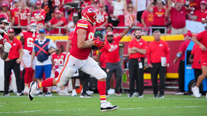 Sep 15, 2024; Kansas City, Missouri, USA; Kansas City Chiefs tight end Travis Kelce (87) runs the ball against the Cincinnati Bengals during the game at GEHA Field at Arrowhead Stadium. Mandatory Credit: Denny Medley-Imagn Images