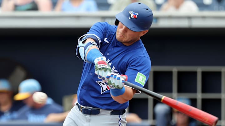 Mar 9, 2025; Port Charlotte, Florida, USA; Toronto Blue Jays outfielder Daulton Varsho (5) doubles during the first inning against the Tampa Bay Rays at Charlotte Sports Park.