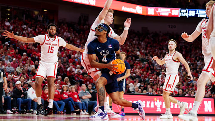 Feb 21, 2026; Lincoln, Nebraska, USA; Penn State Nittany Lions guard Kayden Mingo (4) drives against Nebraska Cornhuskers guard Cale Jacobsen (31) during the second half at Pinnacle Bank Arena. Mandatory Credit: Dylan Widger-Imagn Images