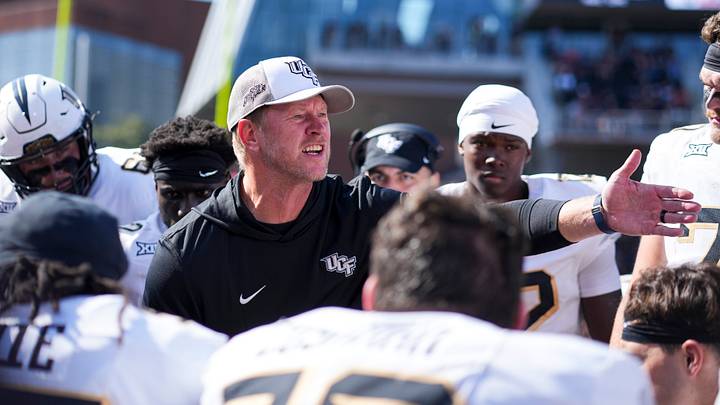 Oct 11, 2025; Cincinnati, Ohio, USA; UCF Knights head coach Scott Frost talks with his team on the sidelines in the game against the Cincinnati Bearcats in the second half at Nippert Stadium. Mandatory Credit: Aaron Doster-Imagn Images