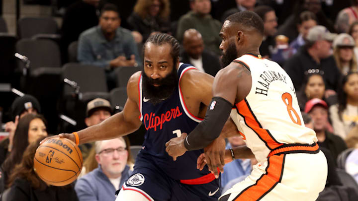 Mar 5, 2025; Inglewood, California, USA; LA Clippers guard James Harden (1) drives against Detroit Pistons forward Tim Hardaway Jr. (8) during the first quarter at Intuit Dome. Mandatory Credit: Jason Parkhurst-Imagn Images