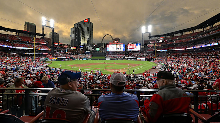 May 26, 2024; St. Louis, Missouri, USA;  Fans wait in their seats as the sun sets while the grounds crew works on the field after storms in the area delayed the start of a game between the St. Louis Cardinals and the Chicago Cubs at Busch Stadium. Mandatory Credit: Jeff Curry-Imagn Images