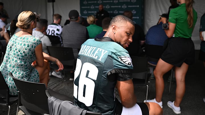 Jul 23, 2025; Philadelphia, PA, USA; Philadelphia Eagles running back Saquon Barkley (26) looks on as offensive lineman Lane Johnson (65) addresses media during training camp at NovaCare Complex. Mandatory Credit: Kyle Ross-Imagn Images