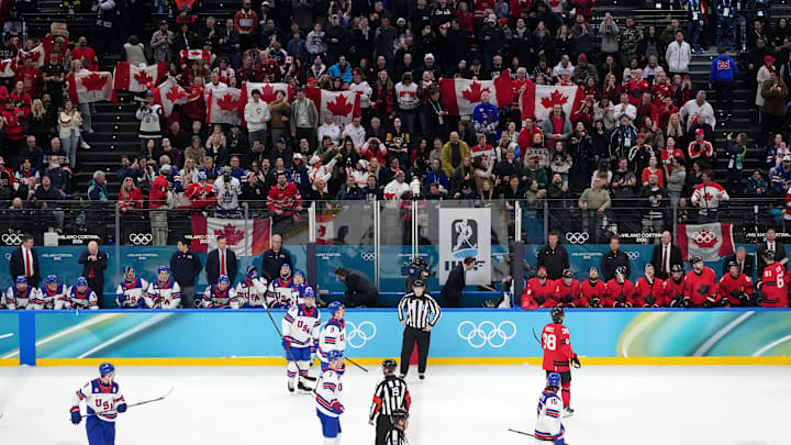 Feb 22, 2026; Milan, Italy; A general view of Canada fans behind the team benches during the men's ice hockey gold medal game during the Milano Cortina 2026 Olympic Winter Games at Milano Santagiulia Ice Hockey Arena. Mandatory Credit: James Lang-Imagn Images Feb 22, 2026; Milan, Italy; A general view of Canada fans behind the team benches during the men's ice hockey gold medal game during the Milano Cortina 2026 Olympic Winter Games at Milano Santagiulia Ice Hockey Arena. Mandatory Credit: James Lang-Imagn Images